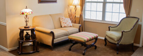 Socialize with a good friend in the sitting area at Bickford of Marion