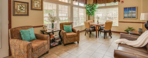 Curl up with a good book in the sunroom at Bickford of Portage