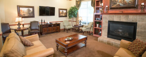 Enjoy a good book in the living room at Bickford of Quincy