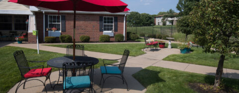 Residents with dementia can enjoy a traveling path, relaxed seating and raised garden beds in the courtyard at Bickford of Quincy