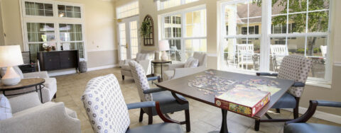 Relax in the warmth of the sunroom at Bickford of Saginaw Township